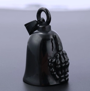 Detail showing embossed skull hand on a polished black motorcycle guardian bell pendant