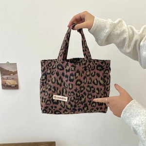 Close-up of pink leopard print faux fur tote bag with soft texture and brand label