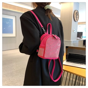 Detail of pink mini backpack with sparkling silver studs and zipper closure