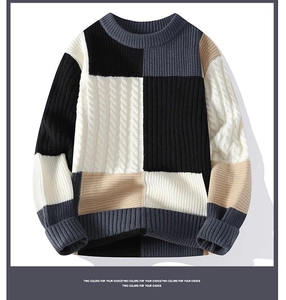 Close-up of crewneck sweater showing multi-color patchwork knit and cable texture