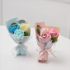 Mini soap rose bouquets in pink and blue wrap with Love is Eternal ribbon on white background