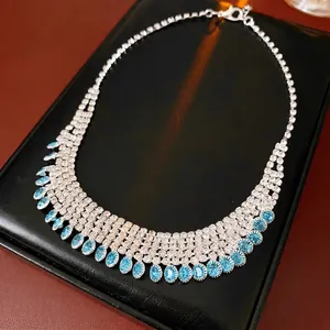 Elegant multi-layer tassel necklace with blue rhinestones on a black leather display