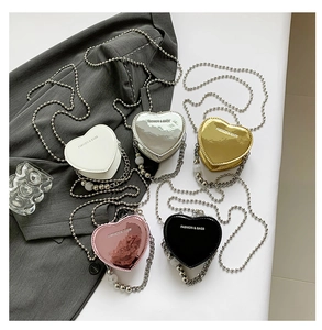 Group display of heart-shaped mini bags in five metallic and glossy colors with chain straps