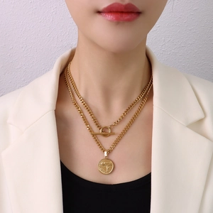 Chunky double-layered gold chain necklace with OT buckle and Uzi gun coin pendant