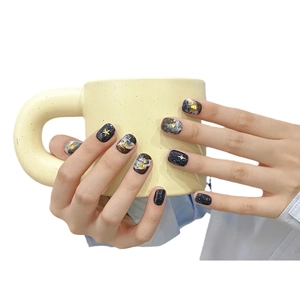 Handmade artistic press-on nails featuring blue galaxy marble patterns and gold foil details