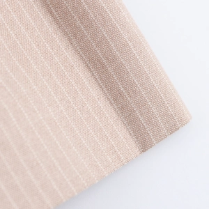 Detailed close-up of beige pinstriped fabric with fine linen texture and vertical stripes