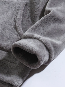 Close-up of soft grey coral fleece hoodie showing thick flannel texture and stitching