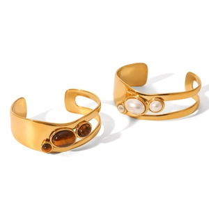 Vintage stainless steel open bangles featuring natural tiger eye and pearl in gold finish