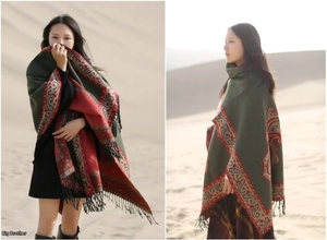 Detailed view of ethnic paisley cashmere shawl with red green contrast and long black tassels