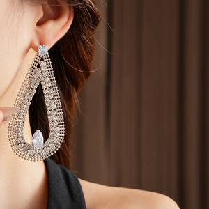 Close-up of a large teardrop earring with cubic zirconia mesh and crystal drop