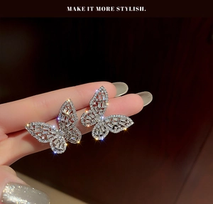 Macro shot of butterfly earrings with sparkling cubic zirconia on a silver-tone base