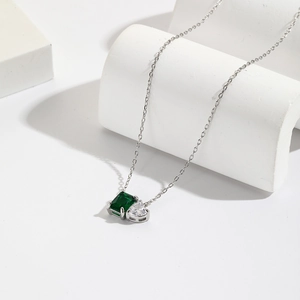 18K gold plated necklace with emerald square stone and heart zircon on white stand