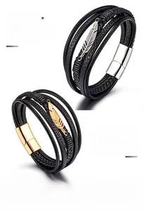 Detail of multi-layer leather braided bracelet with steel feather and magnetic clasp
