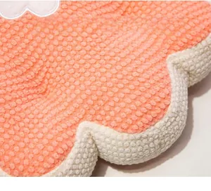 Close-up of pink dotted knit texture and soft rounded edges of a flower cushion