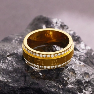 Gold titanium ring with double rows of crystals and roman numerals on dark rock