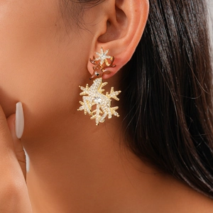 Detail of reindeer stud earring with sparkling crystals and snowflake on ear