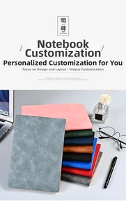 Stack of colorful A5 faux leather business notebooks in a professional office setting
