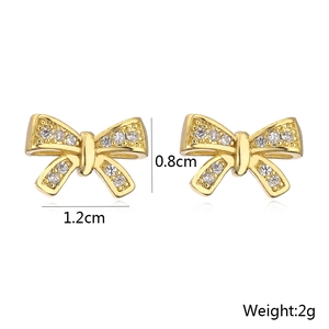 Detail view of gold bow earrings showing precise dimensions 0.8cm by 1.2cm and 2g weight