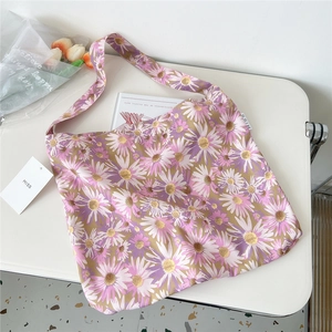 Detailed view of daisy canvas bag with wide shoulder strap and MISS brand label