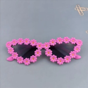 Macro detail of cute pink daisy flower frames on stylish cat-eye girls' sunglasses