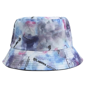 Detailed close-up of a tie-dye bucket hat with a cartoon bear and brand logo design