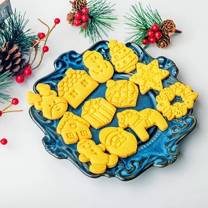 Japanese Christmas cookie cutters set featuring snowman and reindeer on a blue plate