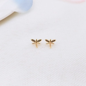 Exquisite 18K gold-plated dragonfly stud earrings with black zircon inlays on white fabric