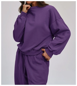 Close-up of deep purple crew neck sweatshirt texture and matching drawstring sweatpants