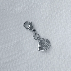 Detailed view of a silver fish-shaped stainless steel pendant with lobster clasp and ring