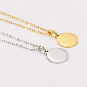 Gold and silver stainless steel necklace with round polished pendant in minimalist style
