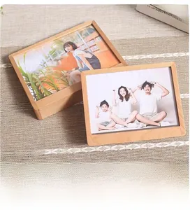 Close-up of minimalist trapezoid beech wood frames with natural grain on a woven mat