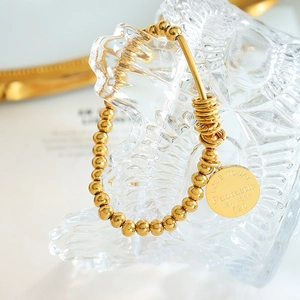 French retro gold bead elastic bracelet with engraved round pendant and steel rings