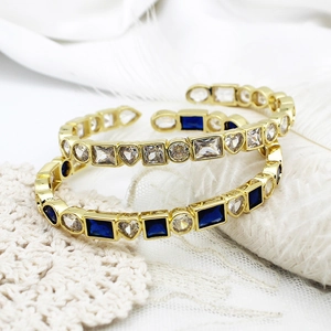 18K gold plated evil eye bracelet with colorful zircons on white silk background