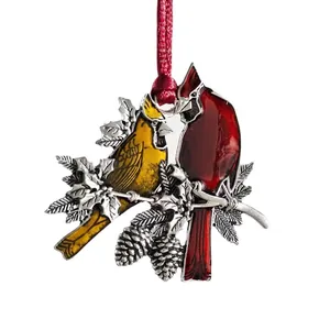 Colorful birds metal ornament on branch with red cord for home holiday decoration