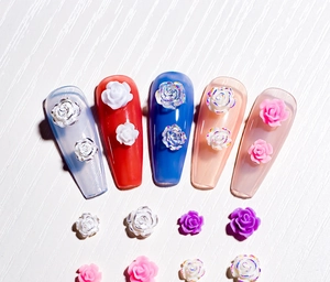 Macro detail of 3D resin rose nail art charms in various sizes and vibrant colors