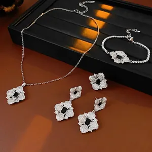 Luxurious silver flower jewelry set with black rectangular stones and zircon accents