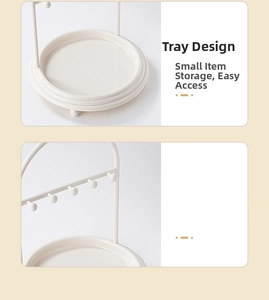 Close-up of cream jewelry rack featuring 5 metal hooks and a round organizer base tray