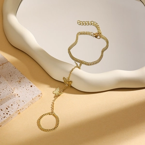 Detail of golden bow hand harness featuring turquoise beads on a white wave tray