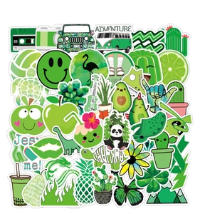 Stack of green waterproof VSCO stickers with avocado and cactus designs for laptops