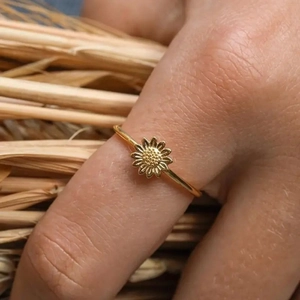 Elegant gold sunflower ring for women with intricate petal texture in warm lighting
