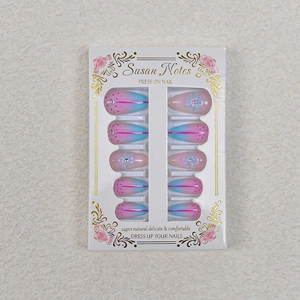 Short almond press-on nails with pink to blue gradient, floral patterns and rhinestones