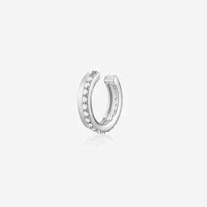 Detail view of a silver cuff earring with sparkling zircon stones and reflective finish