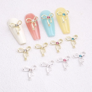 Golden and silver alloy bowknot nail art charms with colorful rhinestones and pearls