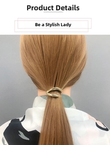 Detail view of a wavy gold alloy ponytail holder clip on hair with a sleek metallic finish