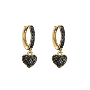 Detail view of gold huggie earrings featuring heart charms with micro-pave black zircon