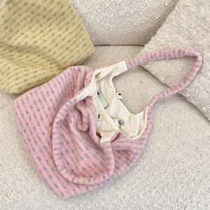 Detail view of pink plush tote bag interior showing lining and spacious capacity