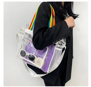 Detailed shot of transparent PVC beach bag with rainbow straps and purple inner pouch