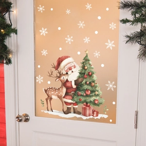 Detail of Christmas window stickers featuring Santa, reindeer, and snowflakes on a glass door