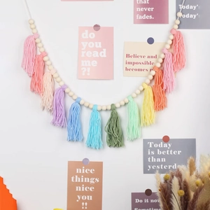 Close-up of bohemian wooden bead garland with colorful rainbow tassels for wall decor