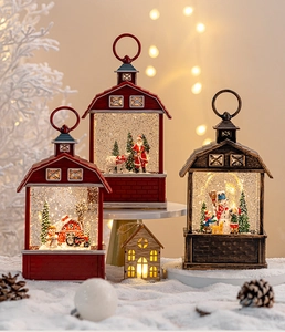 Close-up of lighted Christmas snow globe lanterns with Santa and snowman scenes